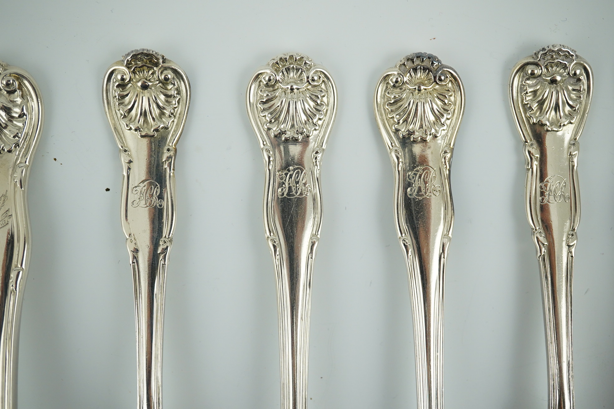 A matched part canteen of George IV and later silver shell scroll pattern flatware